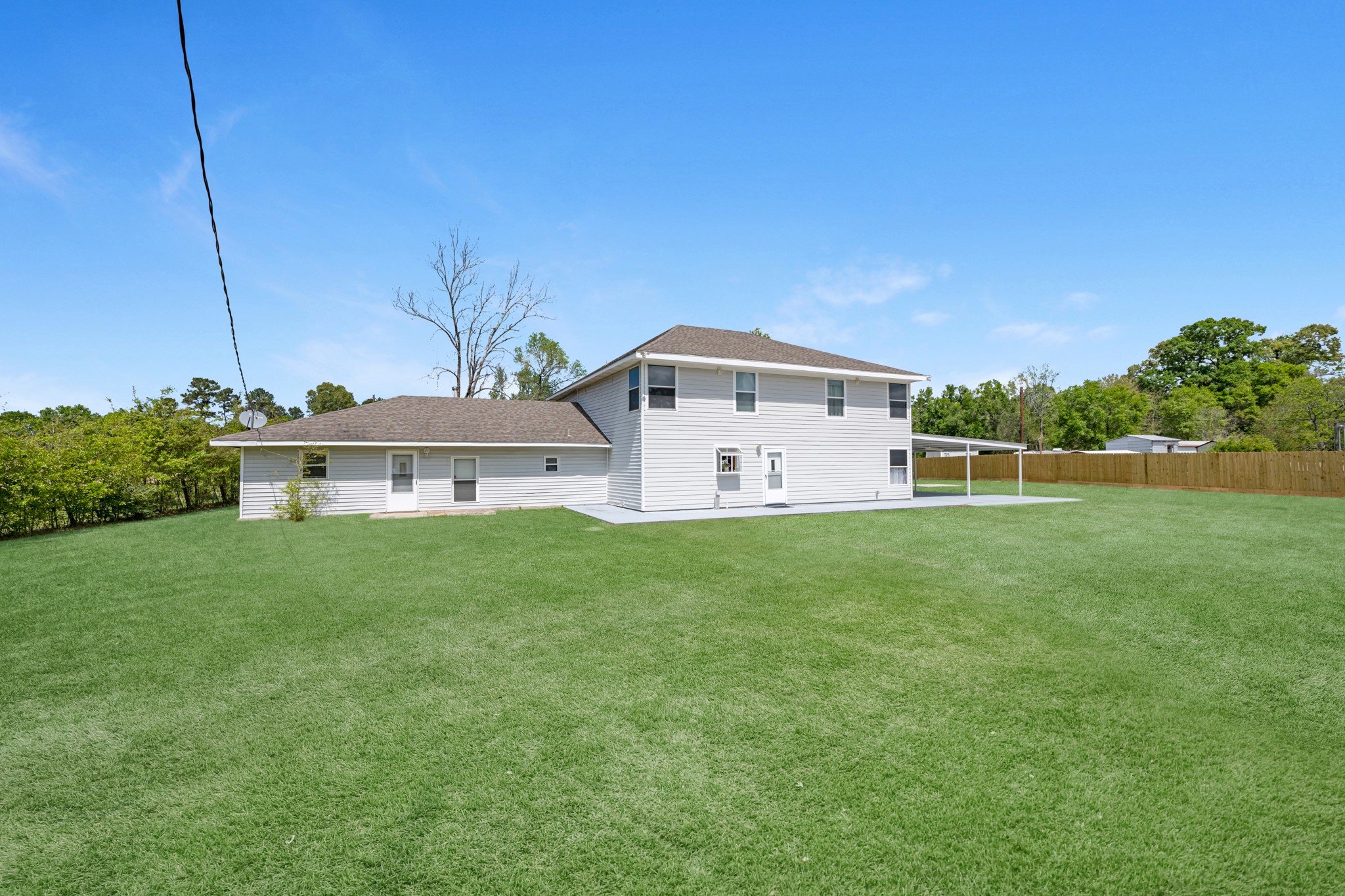 16511 Edgefield Lane Conroe, TX 77302 - Photo 41 of 42 a view of a house with a big yard and large trees