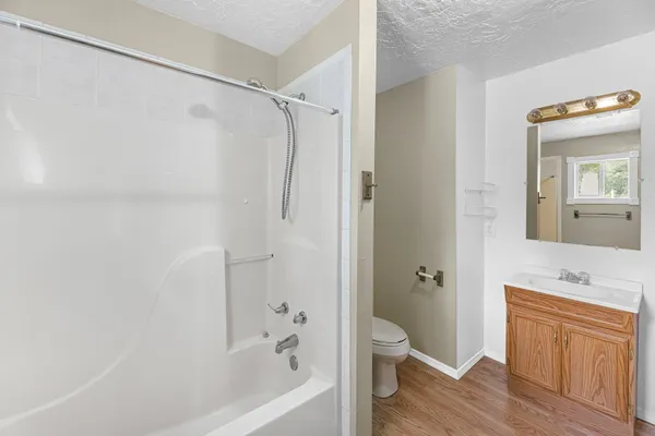 a bathroom with a shower a sink and a mirror