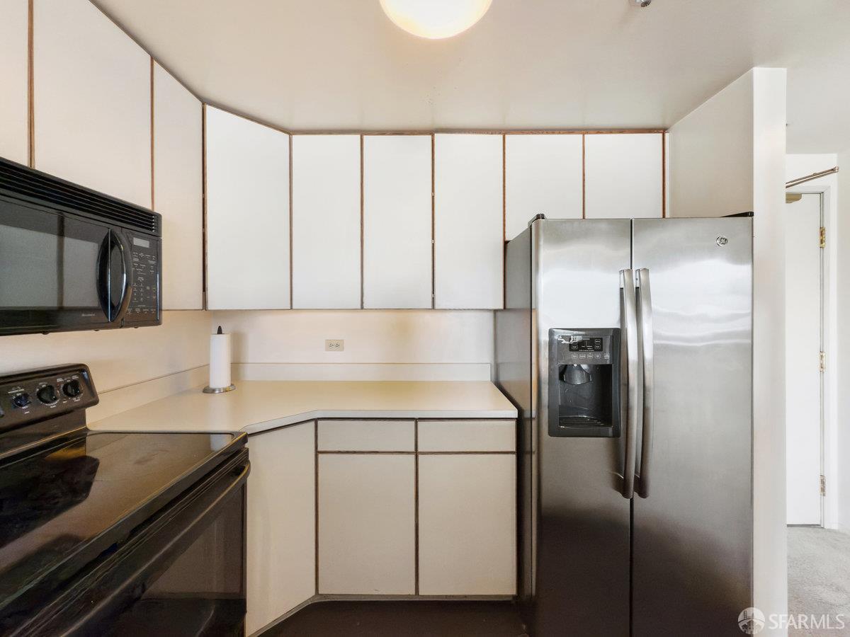 601 Van Ness Avenue, Unit 750 San Francisco, CA 94102 - Photo 14 of 37 a kitchen with a refrigerator sink and cabinets