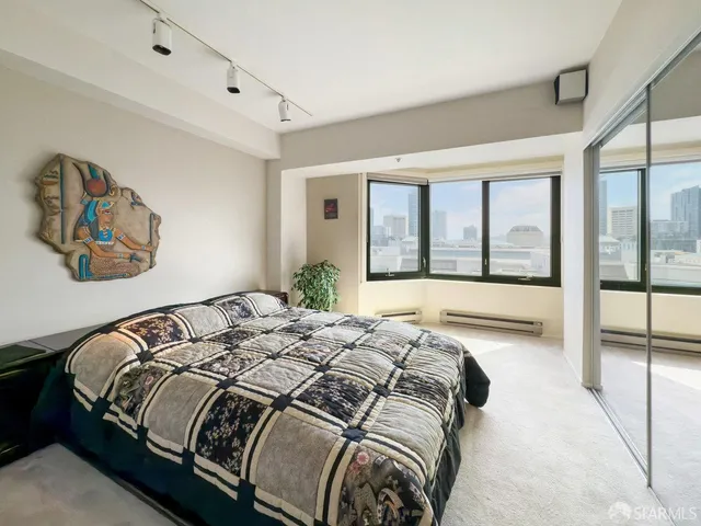 a bed sitting in a bedroom next to a large window