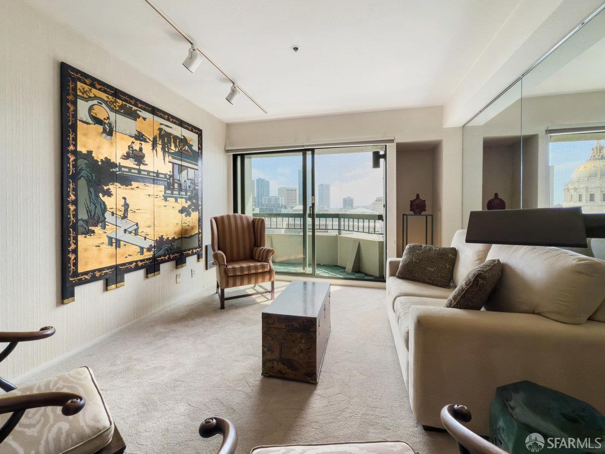 601 Van Ness Avenue, Unit 750 San Francisco, CA 94102 - Photo 20 of 37 a living room with furniture and a flat screen tv