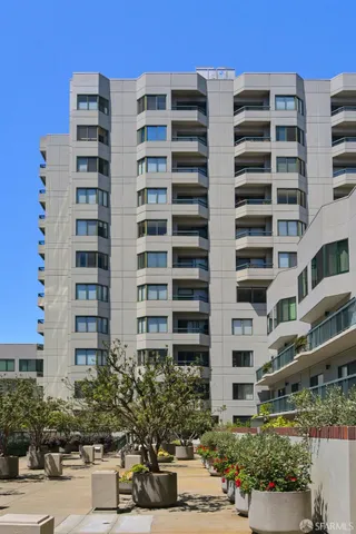 a view of a building with garden and sitting area