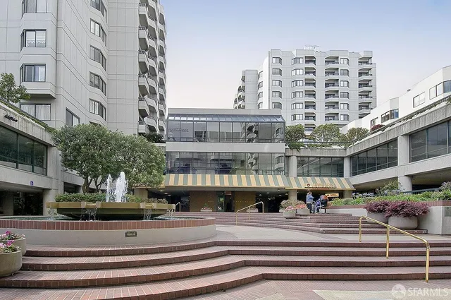 a view of building with yard and sitting area