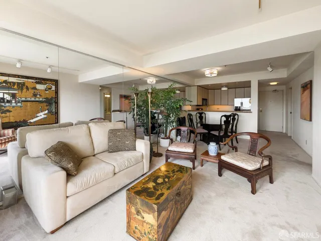 a living room with furniture and kitchen view