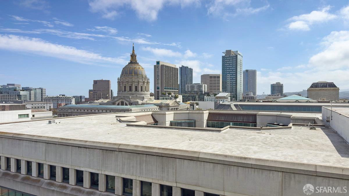601 Van Ness Avenue, Unit 750 San Francisco, CA 94102 - Photo 6 of 37 a kitchen with a sink and a dishwasher with a dining table