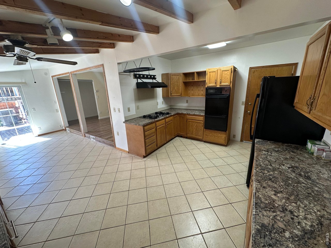 268 Fifth Street Firestone, CO 80520 - Photo 8 of 25 a large kitchen with stainless steel appliances kitchen island granite countertop a refrigerator and a stove