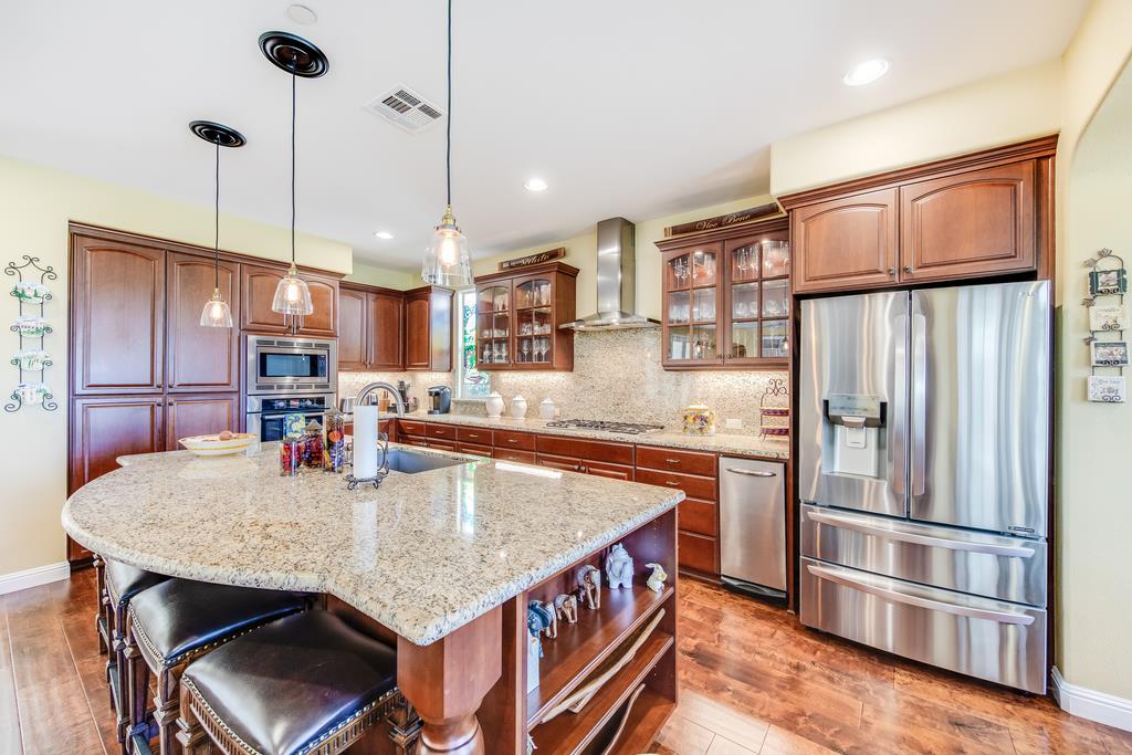 7670 MacKenzie Way Gilroy, CA 95020 - Photo 24 of 70 a kitchen with stainless steel appliances granite countertop a refrigerator a oven and a sink