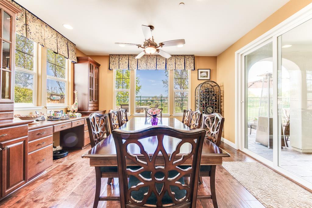 7670 MacKenzie Way Gilroy, CA 95020 - Photo 27 of 70 a view of a dining room with furniture a chandelier and wooden floor