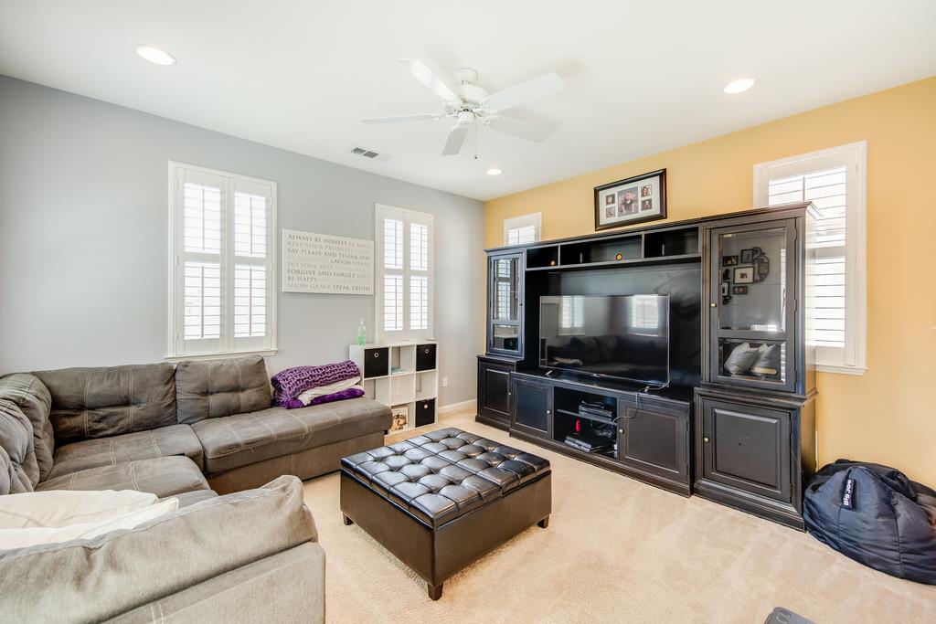 7670 MacKenzie Way Gilroy, CA 95020 - Photo 38 of 70 a living room with furniture and a flat screen tv