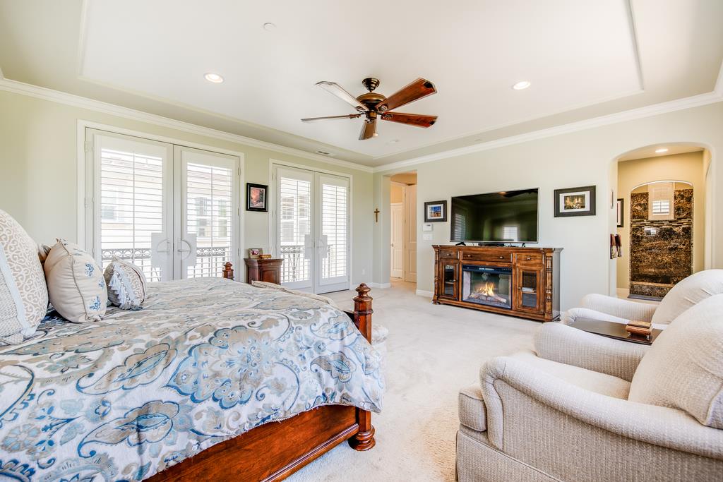 7670 MacKenzie Way Gilroy, CA 95020 - Photo 49 of 70 a bedroom with furniture and a flat screen tv