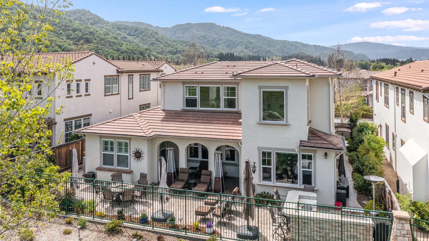 7670 MacKenzie Way Gilroy, CA 95020 - Photo 6 of 70 a view of a white house with large windows next to a road