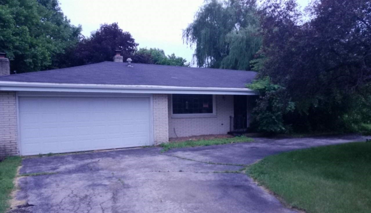 724 Windsor Road Loves Park, IL 61111 - Photo 1 of 11 a backyard of a house with lots of green space and garden
