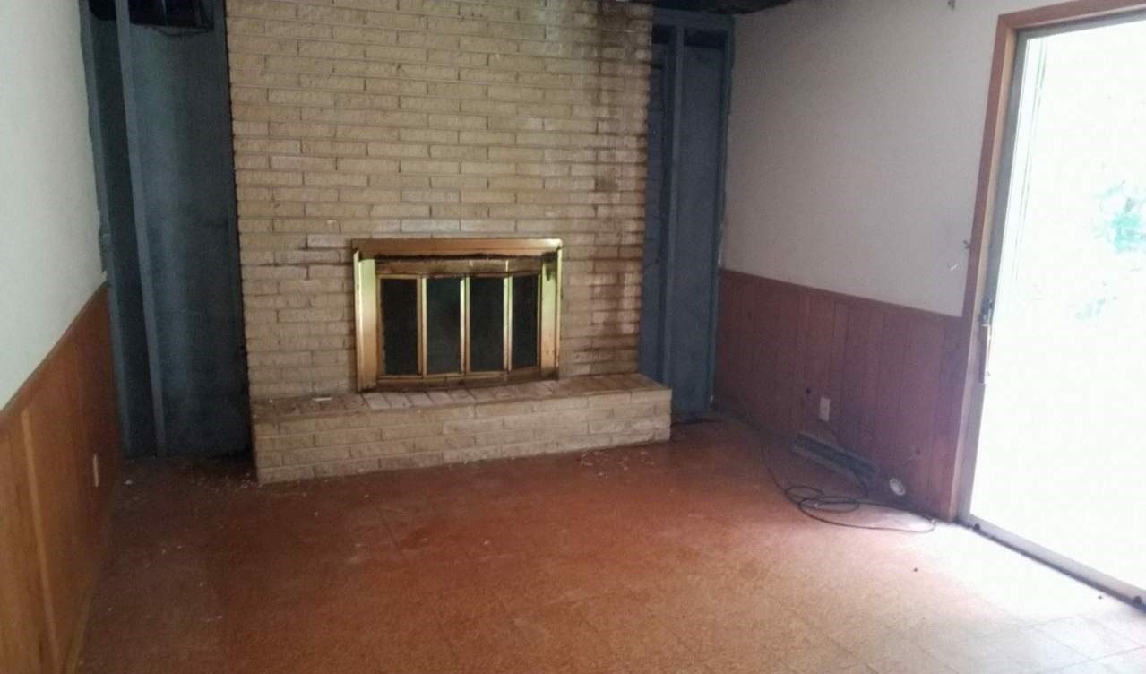724 Windsor Road Loves Park, IL 61111 - Photo 6 of 11 a view of an empty room with a fireplace and a window