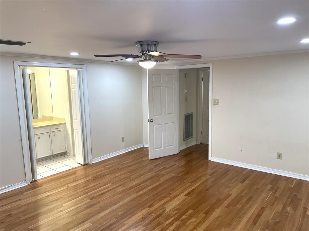 720 Coachlight Road Shreveport, LA 71106 - Photo 19 of 22 wooden floor in an empty room with a window