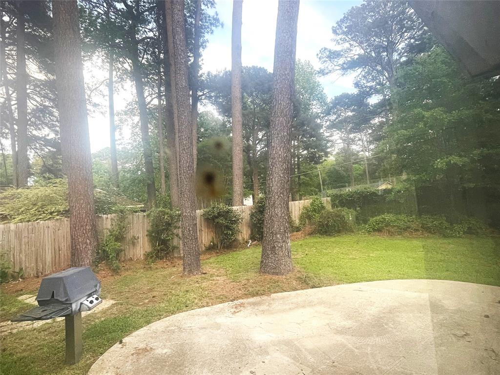 720 Coachlight Road Shreveport, LA 71106 - Photo 22 of 22 a view of backyard with tub and trees