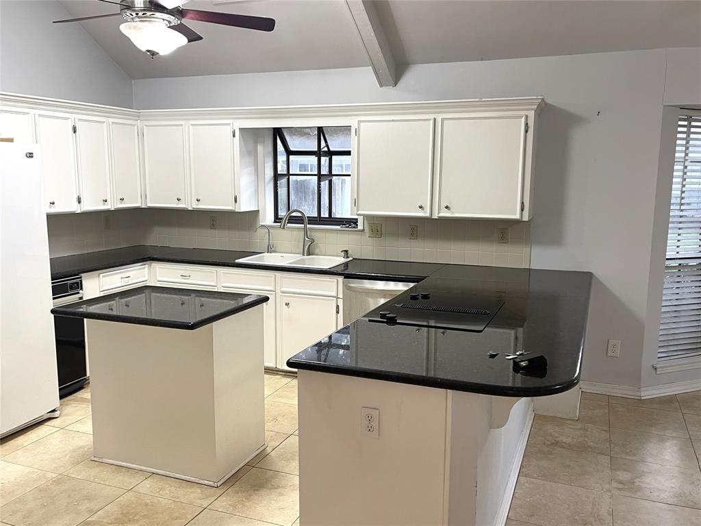 720 Coachlight Road Shreveport, LA 71106 - Photo 5 of 22 a kitchen with stainless steel appliances a sink a stove a refrigerator cabinets and a window