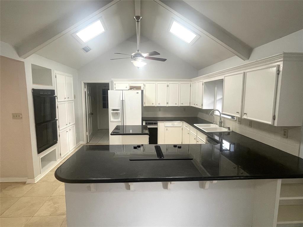 720 Coachlight Road Shreveport, LA 71106 - Photo 6 of 22 a kitchen with kitchen island granite countertop a sink a counter top space and stainless steel appliances