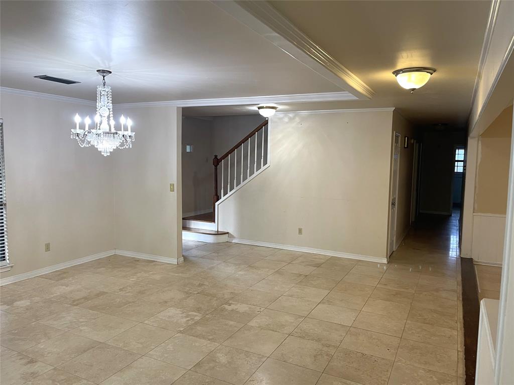 720 Coachlight Road Shreveport, LA 71106 - Photo 10 of 22 a view of an empty room with chandelier and a window