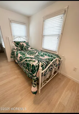 a bed sitting in a bedroom next to a window