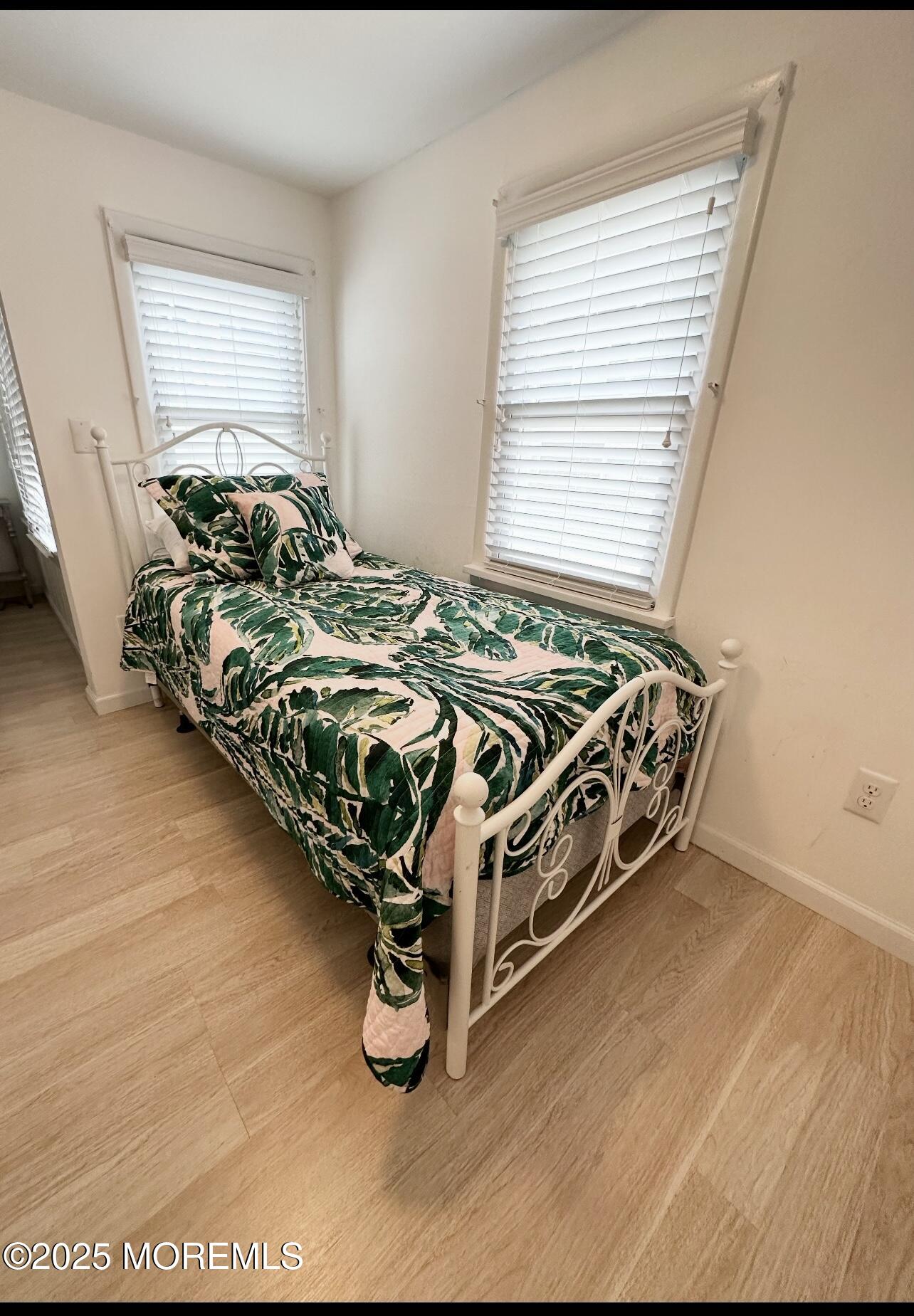 7 Princeton Avenue Lavallette, NJ 08735 - Photo 10 of 17 a bed sitting in a bedroom next to a window