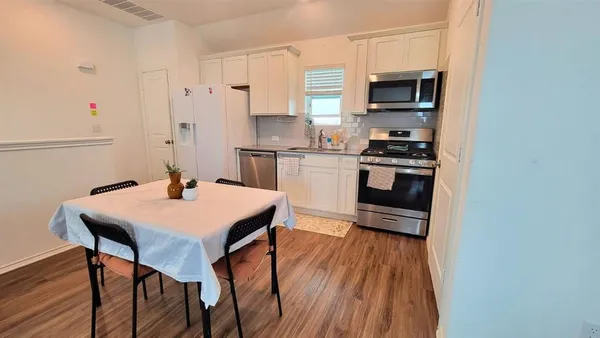 a kitchen with stainless steel appliances a stove a sink dishwasher and a refrigerator