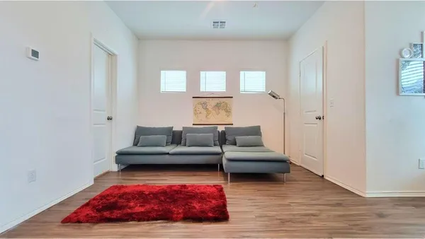 a living room with furniture and a floor to ceiling window