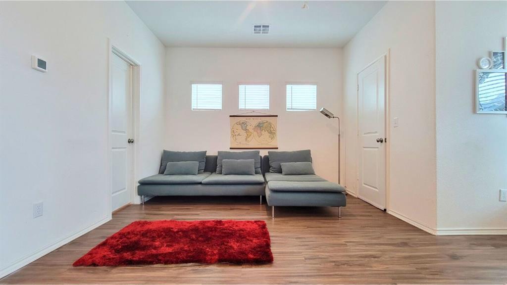 260 Rioja, Unit GARAGE APARTMENT Kyle, TX 78640 - Photo 6 of 13 a living room with furniture and a floor to ceiling window