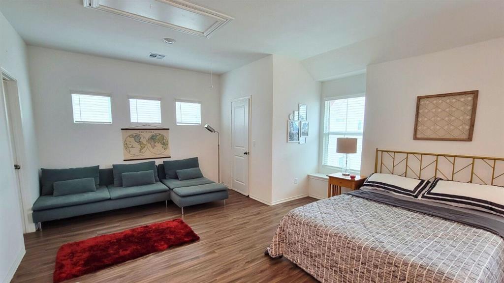 260 Rioja, Unit GARAGE APARTMENT Kyle, TX 78640 - Photo 7 of 13 a spacious bedroom with a bed a couch and a window