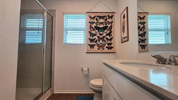 a bathroom with a toilet sink and window