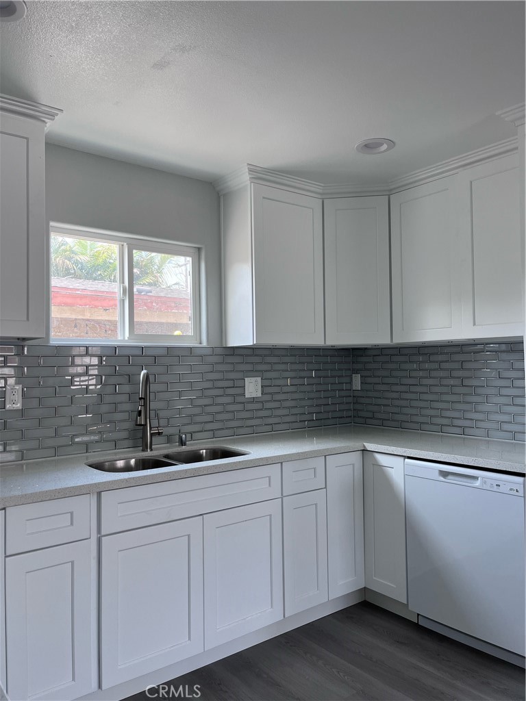 13952 Arthur Avenue Paramount, CA 90723 - Photo 3 of 4 a kitchen with granite countertop white cabinets and sink