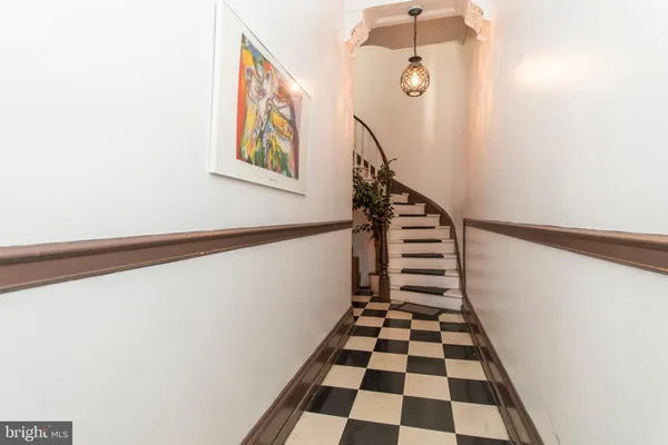 a view of a hallway with windows and white walls
