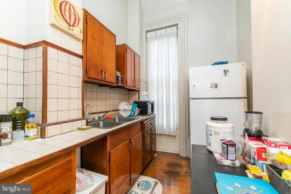 a kitchen with a refrigerator and a sink