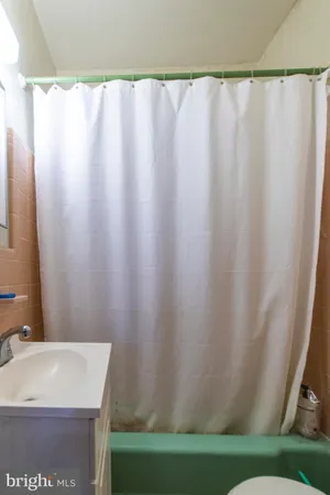 a bathroom with a shower curtain and a sink