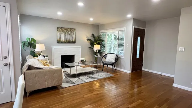 a living room with furniture and a fireplace