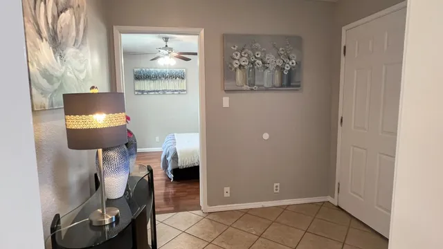 a bedroom with a bed and a potted plant