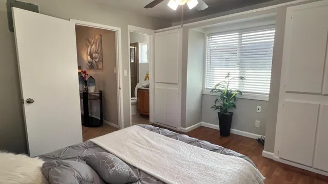 a bedroom with a large bed and a window