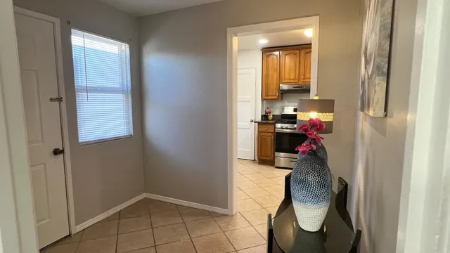 a view of a workspace with furniture and a window