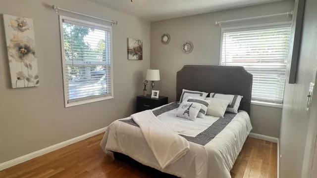 a bedroom with a bed and painting on the wall