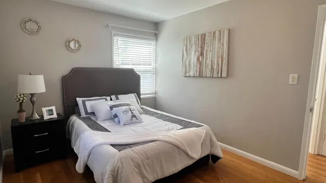 a bedroom with a bed and a painting on the wall