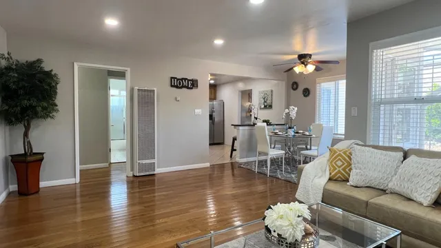a living room with furniture and wooden floor