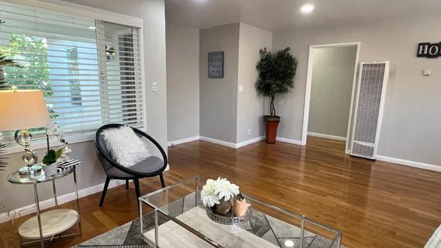 a kitchen with stainless steel appliances a dining table chairs and couches