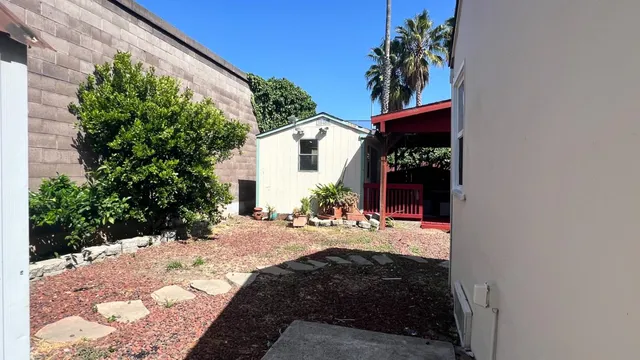 a front view of a house with a yard and fountain