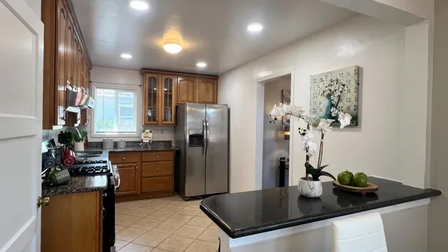 a kitchen with a stove a sink and cabinets