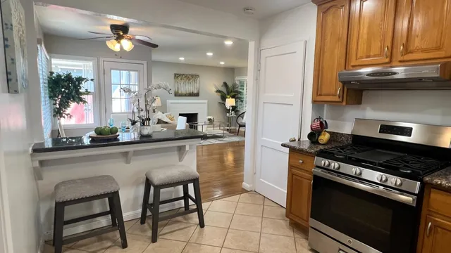 a kitchen with stainless steel appliances granite countertop a stove a sink and a microwave