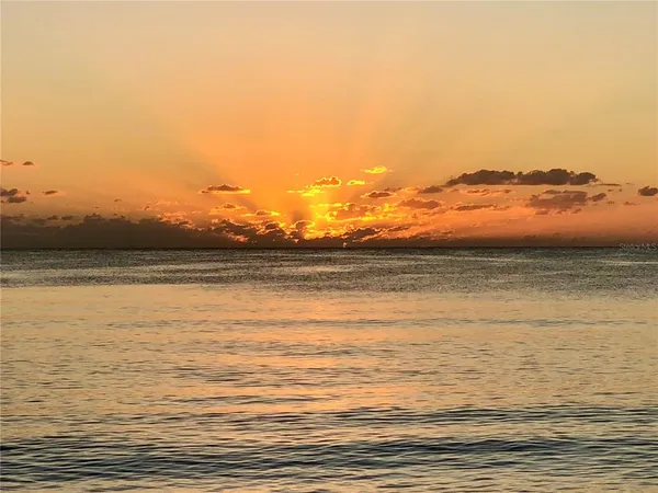 a view of ocean with sunset