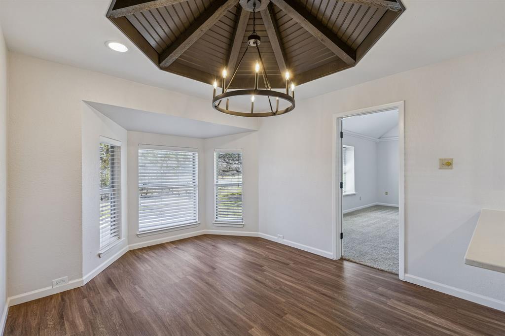 608 Knightsbridge Road Willow Park, TX 76087 - Photo 12 of 31 an empty room with wooden floor cabinet and windows