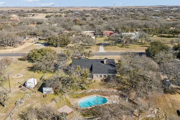 an aerial view of residential houses with outdoor space