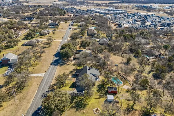 an aerial view of residential houses with outdoor space