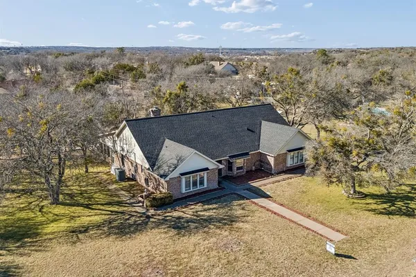an aerial view of houses with a yard