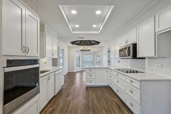 a kitchen with stainless steel appliances a stove sink and cabinets